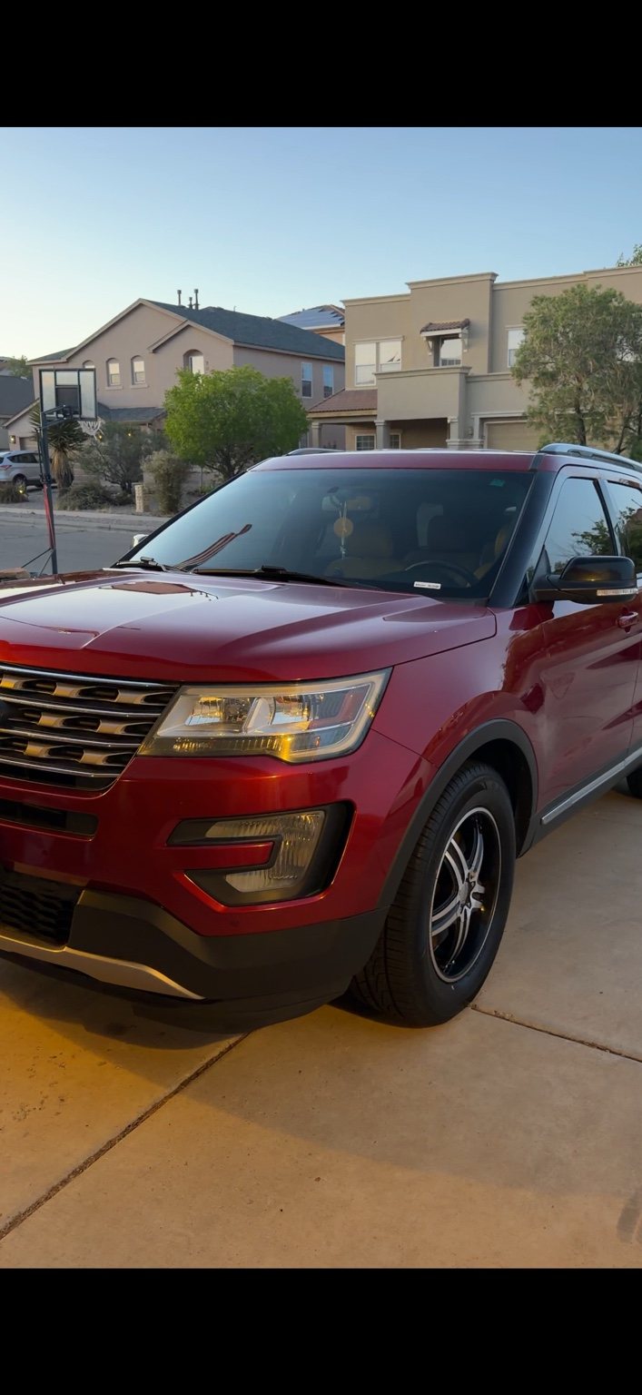 Red Ford Explorer photographed from the front after exterior detailing